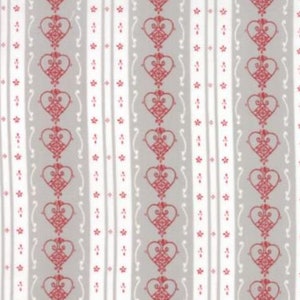May include: Fabric with a repeating pattern of red hearts and small red flowers on a gray and white striped background. The fabric has a ruler along the bottom edge.