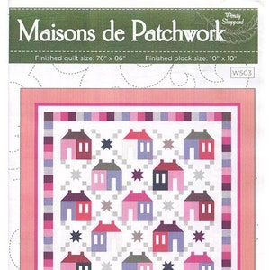 May include: A quilt pattern titled "Maisons de Patchwork" featuring a repeating pattern of colorful houses and star shapes. The finished quilt size is 76" x 86", with a block size of 10" x 10". The design includes pink, purple, and gray houses.