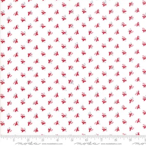 May include: White fabric with a repeating pattern of small red bows and silver swirls. The bows are evenly spaced across the fabric, creating a delicate and festive design. The fabric is suitable for quilting and crafting.