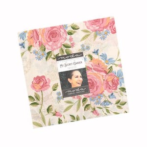 May include: A square fabric piece with a floral pattern featuring large pink roses, small blue flowers, and green leaves on a cream background. A label reads "My Secret Garden" with a woman's image.