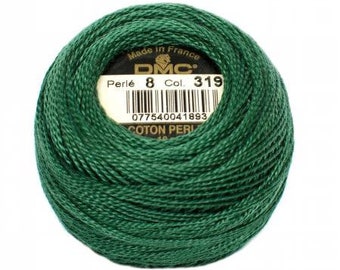 May include: A ball of dark green DMC Perle cotton thread, with a label showing "Made in France", Perle 8, Col. 319, and a barcode. The thread is tightly wound, and the label is visible in the center.