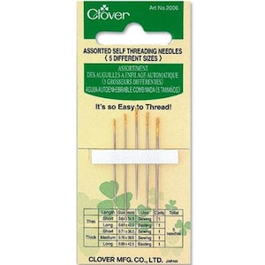 May include: A package of Clover assorted self-threading needles in five different sizes. The package is green and white with text in English, French, and Spanish. The needles are thin and gold-colored, with measurements in millimeters.