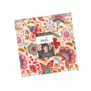 May include: A square stack of fabric squares featuring a cream background with a multi-colored floral pattern in shades of red, pink, blue, and orange. A paper label on top displays the text moda, Sitara, and FABRICS + SUPPLIES.