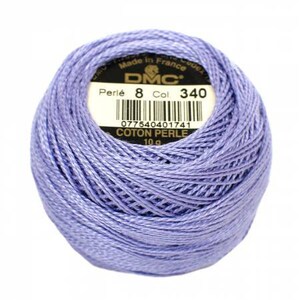 May include: A ball of DMC Perle 8 cotton thread in a light purple hue. The label reads "Made in France" and includes the color number 340. The thread weighs 10g.
