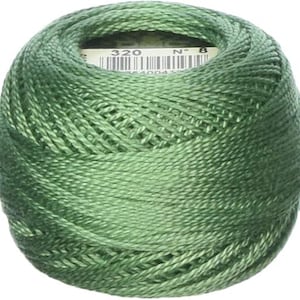 May include: A ball of green embroidery thread, tightly wound. The thread is a muted green color. A label is visible in the center of the ball, with the number "320" and "N° 8" printed on it.
