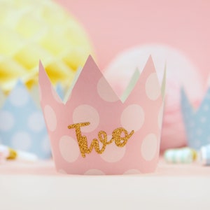 May include: Pink and white polka dot paper crown with gold glitter lettering that says "Two".