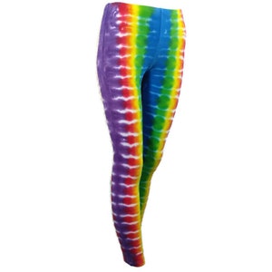 May include: Rainbow tie-dye leggings with a vertical pattern. The leggings are made of a soft, stretchy fabric and are perfect for everyday wear.
