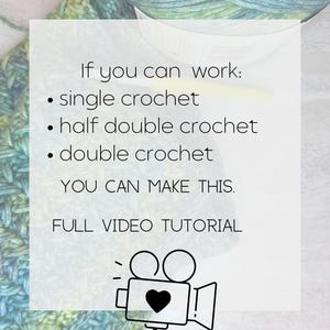 A white square with black text that reads 'If you can work: single crochet, half double crochet, double crochet YOU CAN MAKE THIS. FULL VIDEO TUTORIAL.' There is a black and white illustration of a video camera with a heart in the viewfinder.
