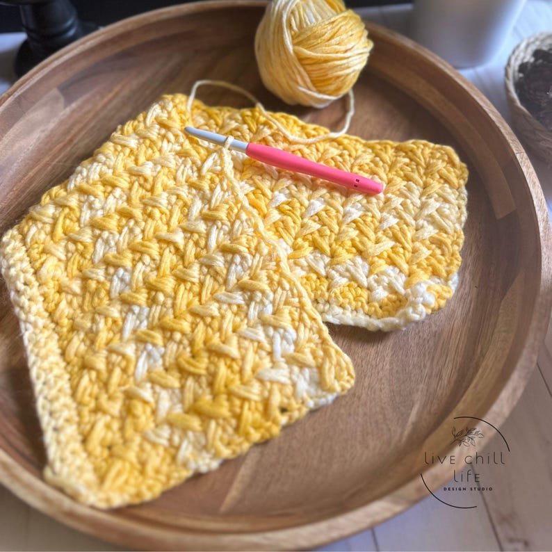 A close-up of a white and yellow gradient crocheted blanket with a textured chevron pattern. it is an emotional support crochet stitch easy meditative with a calming fishtail appearance.