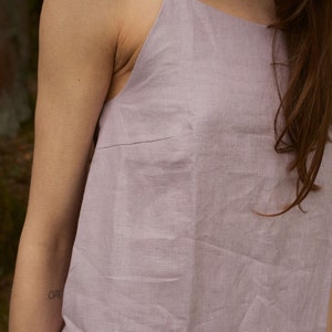 May include: A light purple linen sleeveless dress with a square neckline.