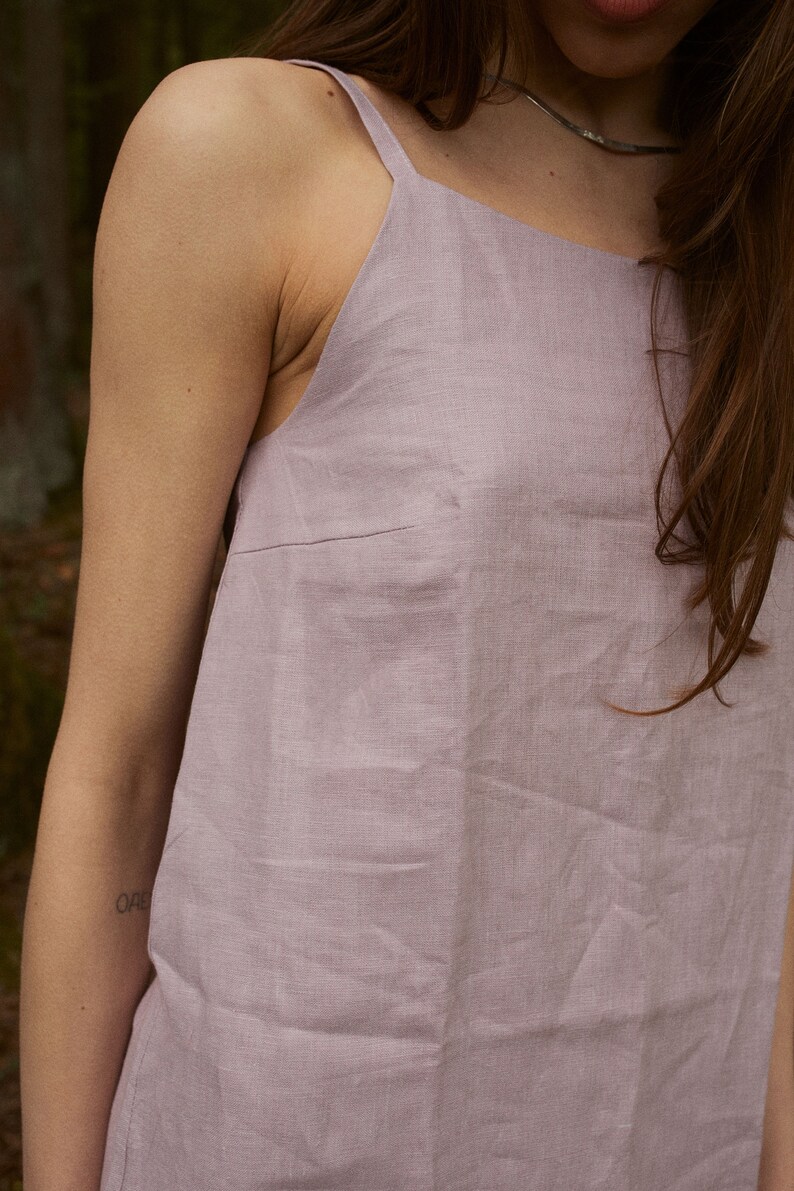 May include: A light purple linen sleeveless dress with a square neckline.