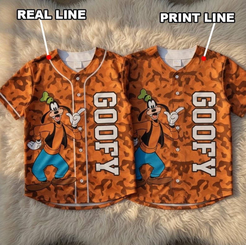 May include: Two short-sleeved button-down baseball jerseys featuring an orange camouflage pattern and a graphic of the character Goofy. The shirts display the text GOOFY in white block letters. Labels indicate REAL LINE and PRINT LINE.