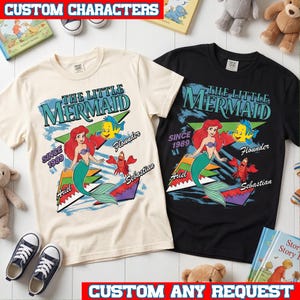 May include: Two short-sleeve t-shirts, one cream and one black, featuring a graphic print of The Little Mermaid with Ariel, Flounder, and Sebastian. The design includes the text "The Little Mermaid," "Since 1989," "Ariel," "Flounder," and "Sebastian" in colorful, retro-style lettering.
