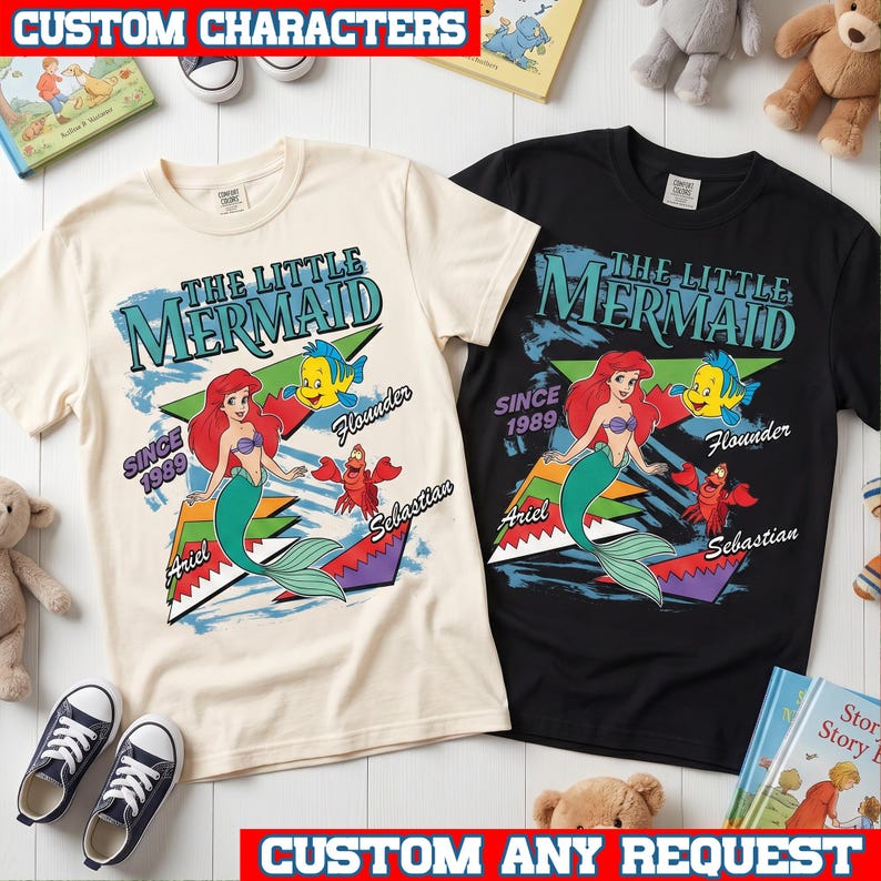 May include: Two short-sleeve t-shirts, one cream and one black, featuring a graphic print of The Little Mermaid with Ariel, Flounder, and Sebastian. The design includes the text "The Little Mermaid," "Since 1989," "Ariel," "Flounder," and "Sebastian" in colorful, retro-style lettering.