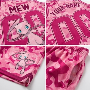 May include: A pink camouflage mesh basketball jersey and shorts set featuring the character Mew, the text MEW or YOUR NAME, and the number 00 in large dark pink font. The athletic apparel includes a sleeveless top and shorts with side pockets.