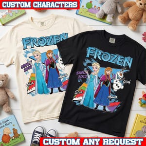 May include: Two short-sleeve t-shirts, one cream and one black, featuring a graphic print of Frozen characters Elsa, Anna, and Olaf. The design includes the text Frozen, Since 2013, Elsa, Anna, and Olaf, with colorful geometric shapes in the background.