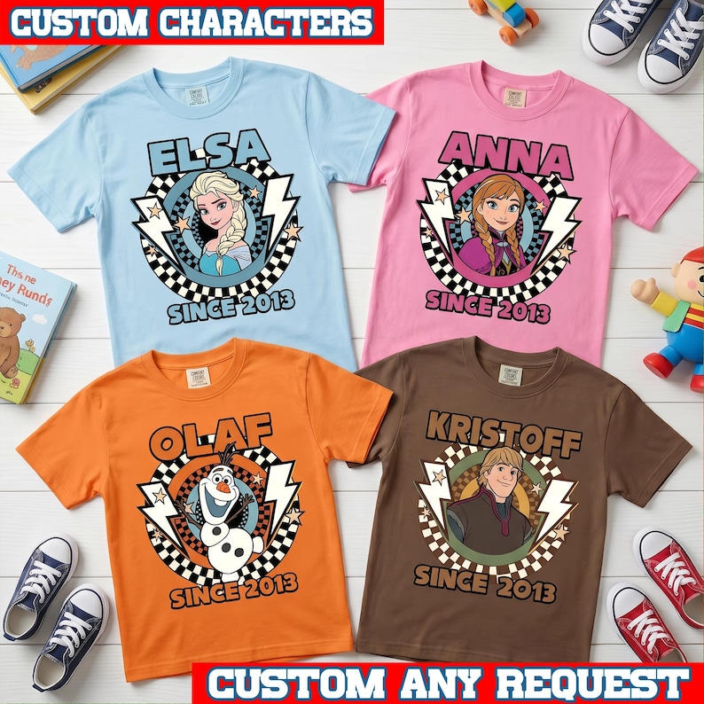 May include: Four short-sleeve t-shirts in light blue, pink, orange, and brown. Each features a circular graphic with a character from Frozen, lightning bolts, a checkered border, and the text "SINCE 2013" below the character's name.