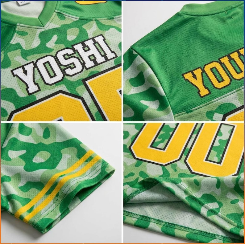 May include: A green and light green camouflage mesh jersey featuring the name YOSHI in white block letters with black outlines. The garment includes large yellow numbers with black outlines on the front and sleeves, and yellow stripes on the cuffs.