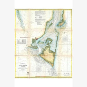 May include: A vintage nautical chart of the Cape Fear River, North Carolina, with detailed markings and annotations. The chart is printed on aged paper with a light yellowed hue and includes a compass rose and a scale bar.