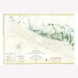 May include: A vintage nautical chart titled "Florida Reefs" with detailed illustrations of the ocean floor and surrounding islands. The chart features a grid pattern, compass rose, and text including "Coast Chart No. 51". The map is in shades of blue, green, and beige.