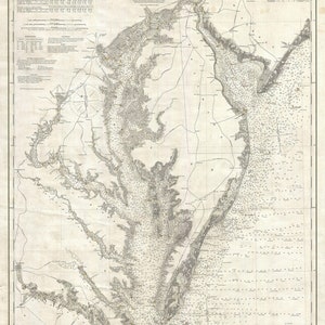 May include: A vintage map of Delaware and Chesapeake Bays, showing the coastline, waterways, and surrounding land. The map is printed in black and white on a cream-colored paper. The title "Delaware and Chesapeake Bays" is printed at the top of the map.