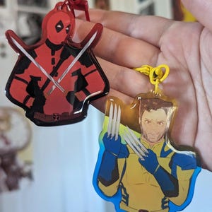 Deadpool and Wolverine 2 sided Charms feat Unmasked Wade Wilson and X Men Logan Keychain