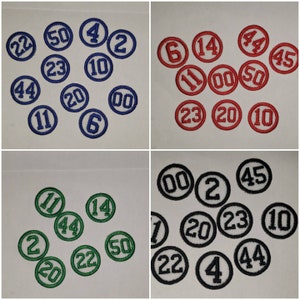 May include: Assortment of round, embroidered patches with numbers from 0 to 50. The patches are in three colors: blue, red, and green.