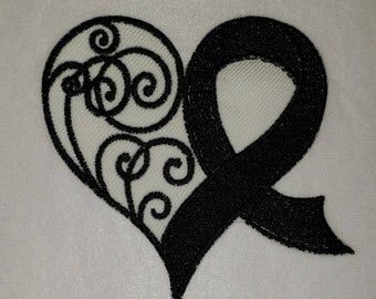 May include: Black embroidered heart design with a ribbon on a white background. The heart features an intricate, swirling pattern on the left side. The ribbon is solid black and appears to be a symbol of remembrance or support.