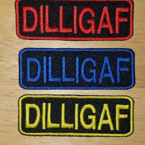 May include: Three embroidered patches with the text "DILLIGAF" in red, blue, and yellow lettering on a black background.