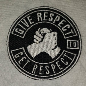 May include: A black and white embroidered patch with the text "Give Respect To Get Respect" and a white fist in the center.