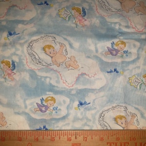 May include: Vintage baby-themed fabric with a light blue background. The fabric features illustrations of cherubic babies, angels with wings, and bluebirds. The babies are in white cradles with pink trim, and the angels hold flowers.