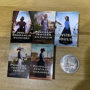 May include: Five paperback books with colourful covers featuring women in vintage clothing. The book titles are "Joulu Örndahlin Ruukissa", "Puuvilla-Tehtaan Kilpailija", "Loviisan Joulu", "Puuvilla-Tehtaan Perijä", and "Puuvilla-Tehtaan Varjossa".