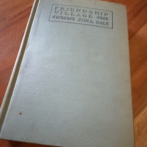 May include: A light green hardcover book with the title "Friendship Village" by Zona Gale.