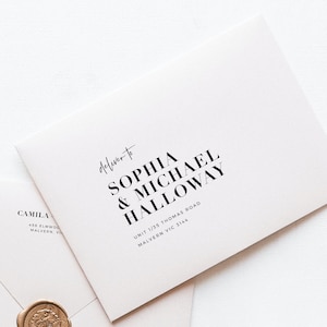 May include: A white envelope with the text "Deliver to SOPHIA & MICHAEL HALLOWAY" in black. The address is also printed in black. A second envelope and a wax seal are partially visible.