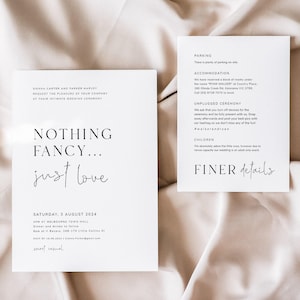 May include: Two white wedding invitation cards with black text. One card reads "Nothing Fancy... just love" and includes event details. The other card lists parking, accommodation, and unplugged ceremony information. Gold rings are in the background.