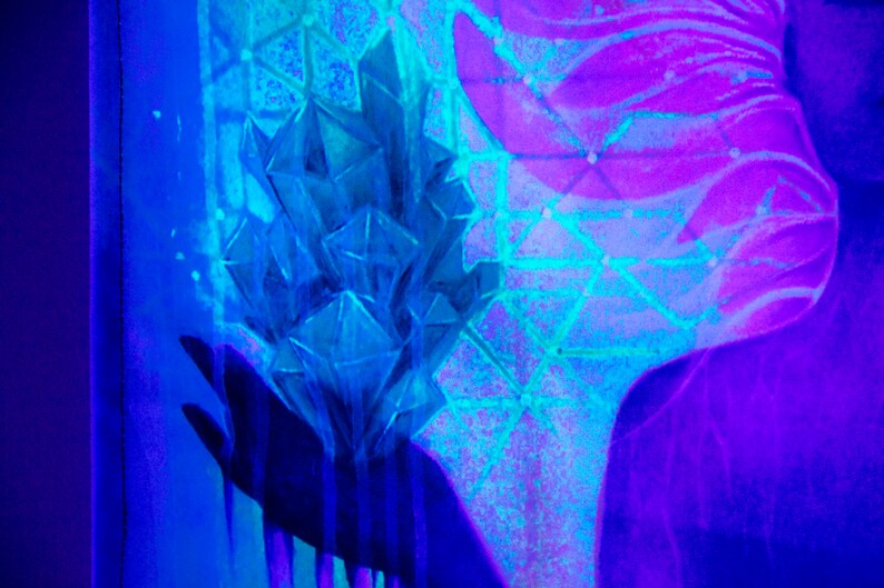 May include: A blue crystal cluster with a geometric pattern in the background. The crystal cluster is illuminated with a blue and purple light.