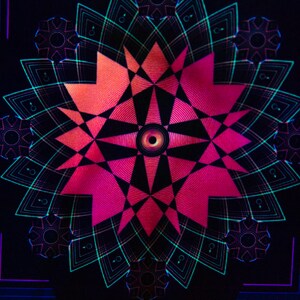 May include: Abstract digital art featuring a symmetrical design with a central eye-like shape. The artwork uses a palette of pink, orange, teal, and black, creating a vibrant and geometric pattern. The design has a psychedelic feel.