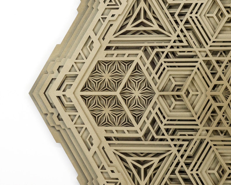 May include: A layered geometric design with intricate cutouts, creating a 3D effect. The design is made of a light brown material and has a hexagonal shape.