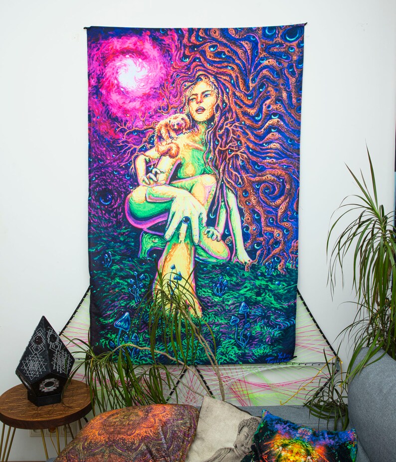 May include: A psychedelic tapestry featuring a woman with long flowing hair and a small animal in her arms. The woman is surrounded by swirling patterns and vibrant colors, including pink, purple, green, and blue. The tapestry is a vibrant and colorful piece of art that would add a unique touch to any room.
