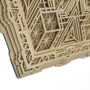 May include: A layered wooden wall art piece with a geometric design. The design features intricate patterns and shapes, creating a visually interesting and textured surface.