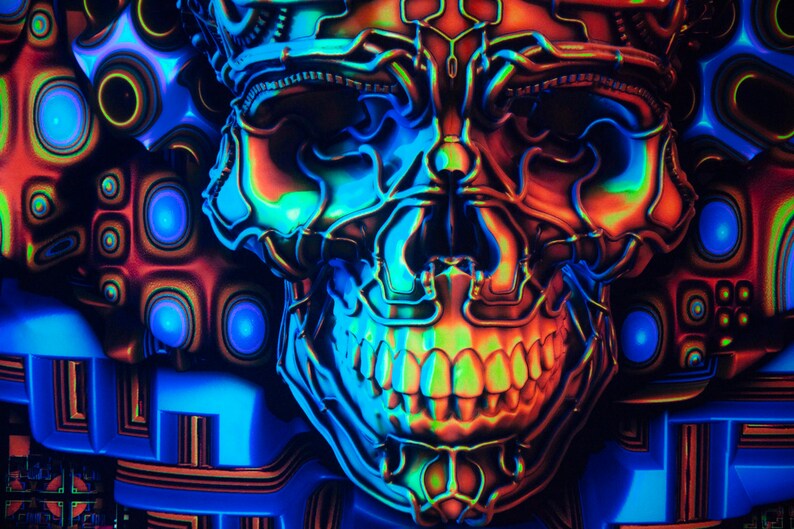 May include: A neon blue, green and orange skull with a detailed, intricate design. The skull is set against a background of geometric shapes and patterns.