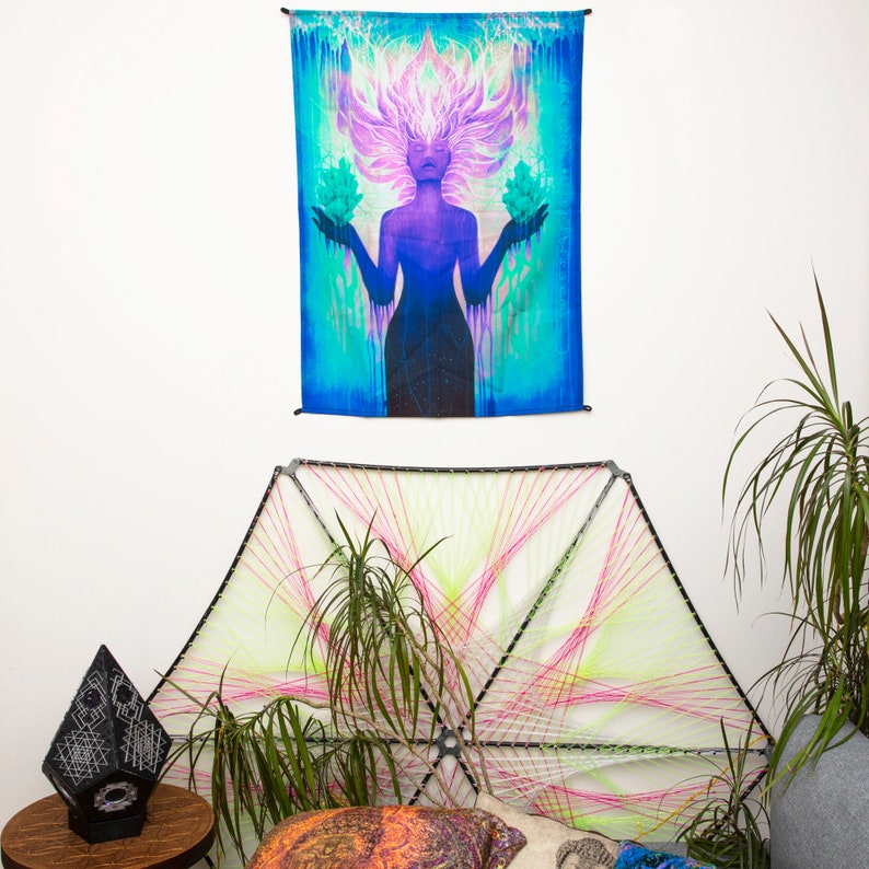 May include: A tapestry featuring a woman with flowing purple hair, holding two green lotus flowers. The background is a vibrant blue and green gradient with a swirling pattern.