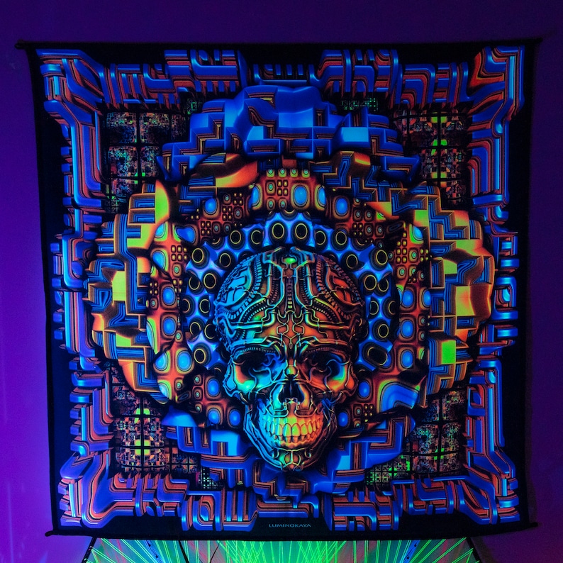 May include: A black tapestry with a psychedelic design featuring a glowing skull with intricate details. The skull is surrounded by geometric patterns in shades of blue, green, orange, and yellow. The tapestry has the word "OMNIORATA" printed at the bottom.