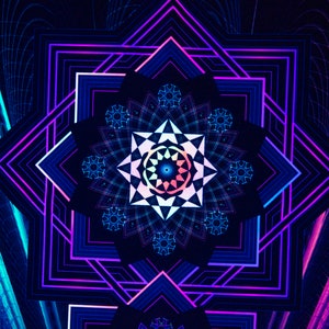 May include: Abstract digital art featuring a symmetrical geometric design. The artwork showcases a central star-like pattern with a gradient of colors, including blue, pink, and purple. The background is dark, with neon lines and shapes.