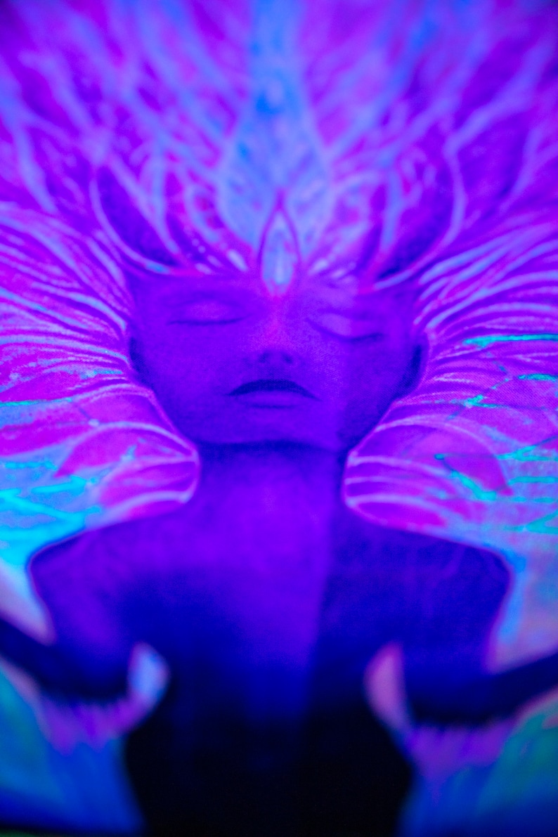 May include: A close-up of a painting depicting a person with their eyes closed. The painting is done in shades of blue and purple, with a swirling pattern around the person's head.