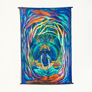 May include: A psychedelic tapestry featuring a colorful depiction of the Hindu deity Ganesha, surrounded by swirling patterns and vibrant colors. The tapestry is made of fabric and has a fringed edge.