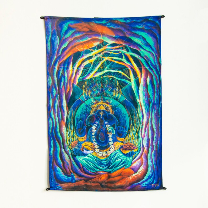 May include: A psychedelic tapestry featuring a colorful depiction of the Hindu deity Ganesha, surrounded by swirling patterns and vibrant colors. The tapestry is made of fabric and has a fringed edge.