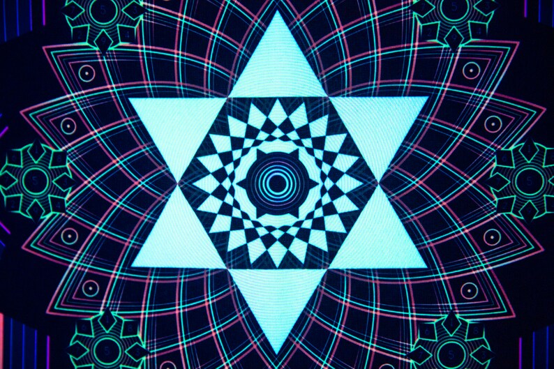 May include: Abstract digital art featuring a central light blue star shape with a checkered pattern, surrounded by a symmetrical design of lines and geometric shapes in shades of pink, green, and blue against a dark background.