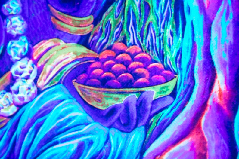 May include: A hand holding a bowl filled with purple and pink berries. The bowl is surrounded by blue and green foliage.