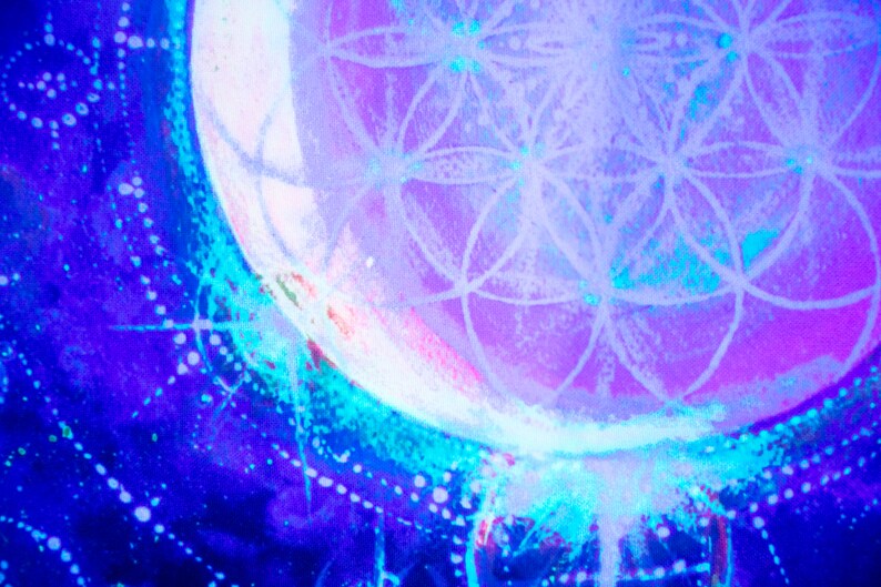 May include: A close-up of a purple and blue abstract painting with a white geometric design in the center. The design resembles a flower or a mandala.